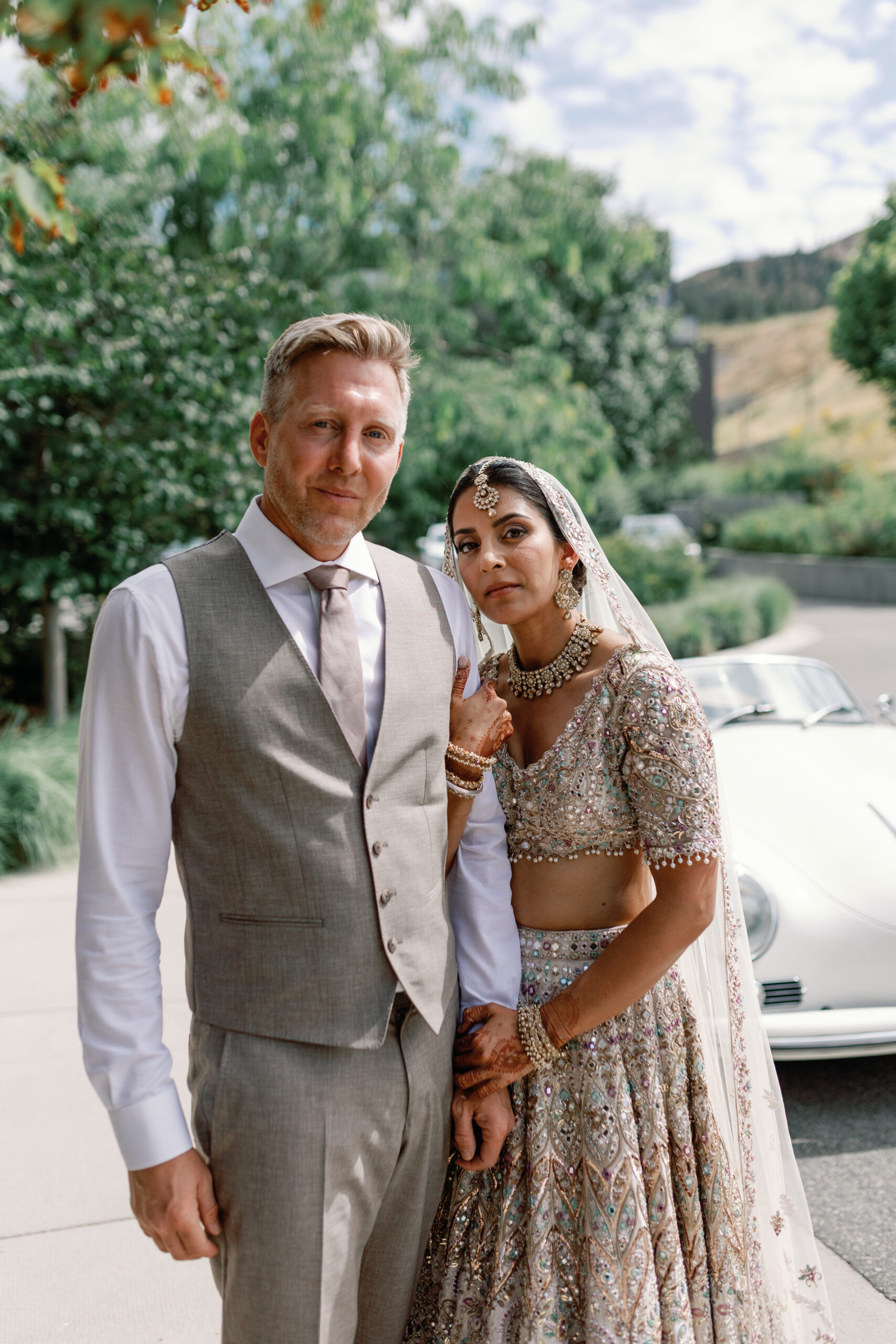 Bride and groom in traditional and modern attire during an Okanagan wedding, beautifully coordinated by a wedding planner.