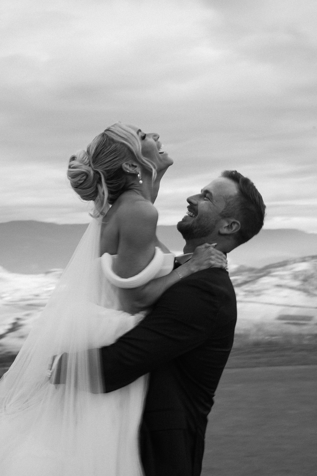 Bride and groom sharing a joyful embrace during their Okanagan wedding at The Rise Resort in Vernon, BC, planned by a professional wedding planner.